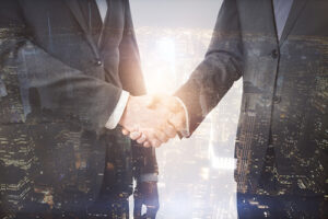 ITM maintenance contract employee shaking hands with branch manager with cityscape overlay